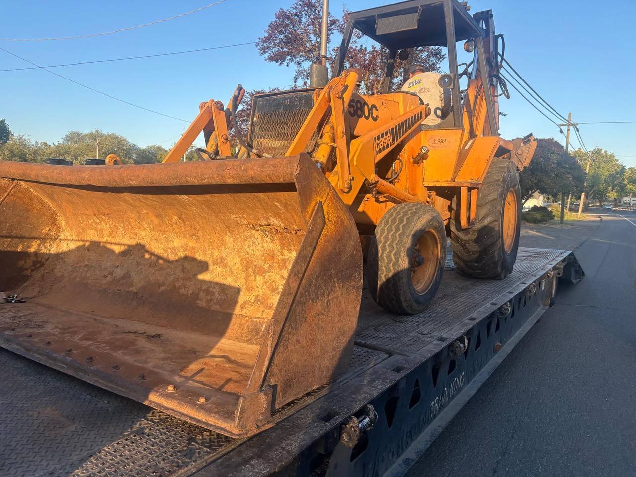 Construction equipment loaded on flatbed transport